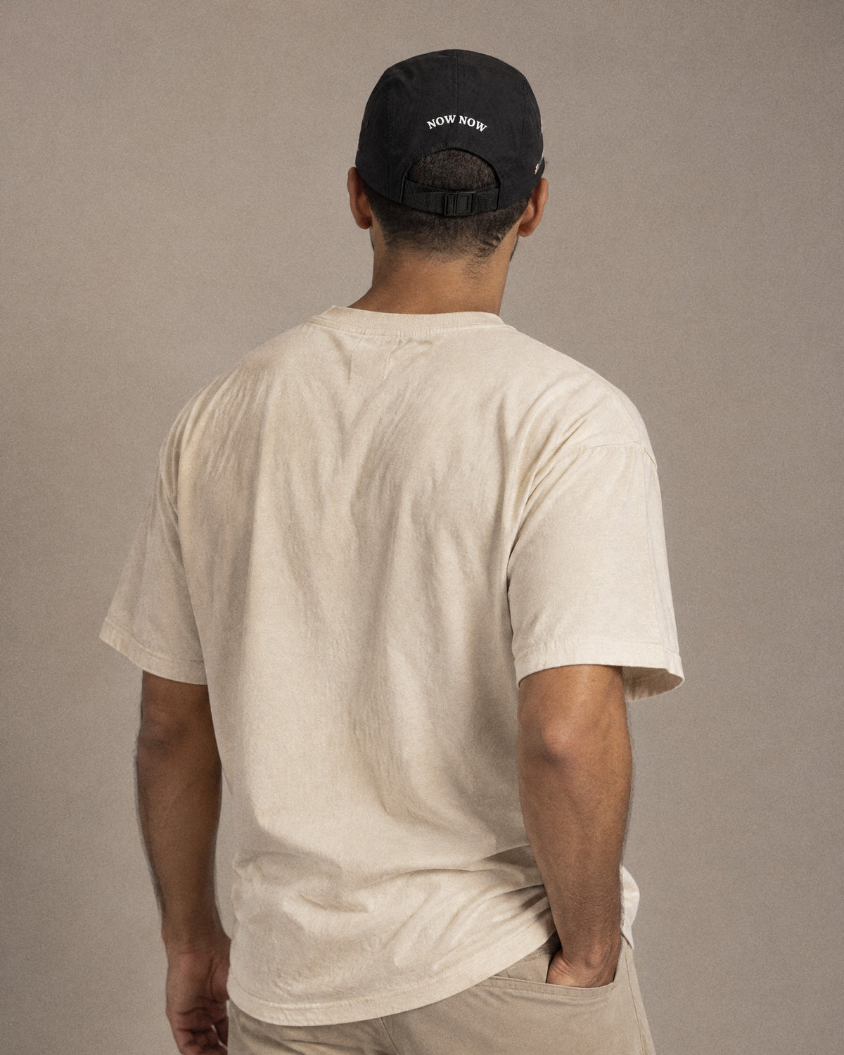 Back of the black Just Now cap in the studio