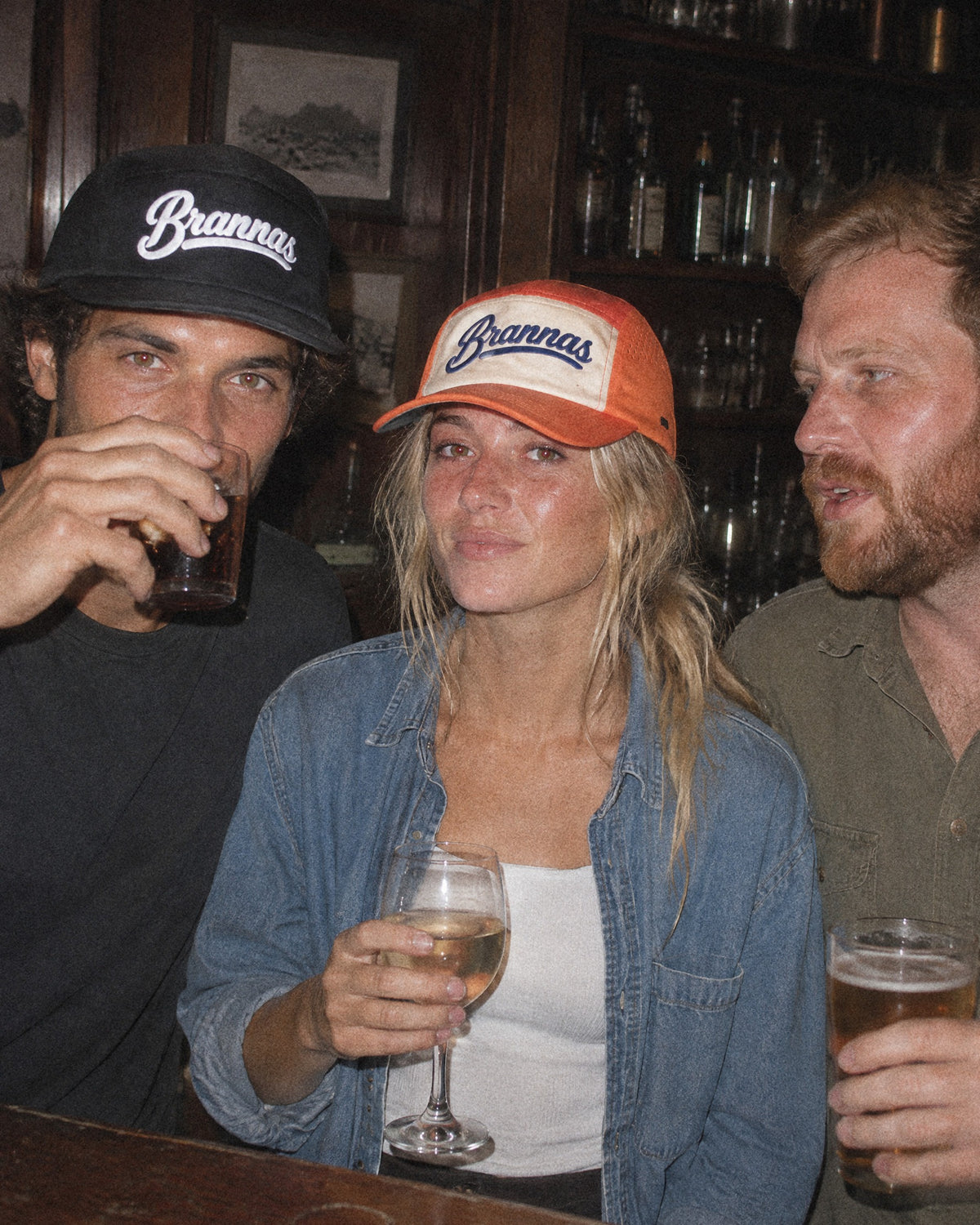 Friends at a Cape bar in black and orange Brannas caps