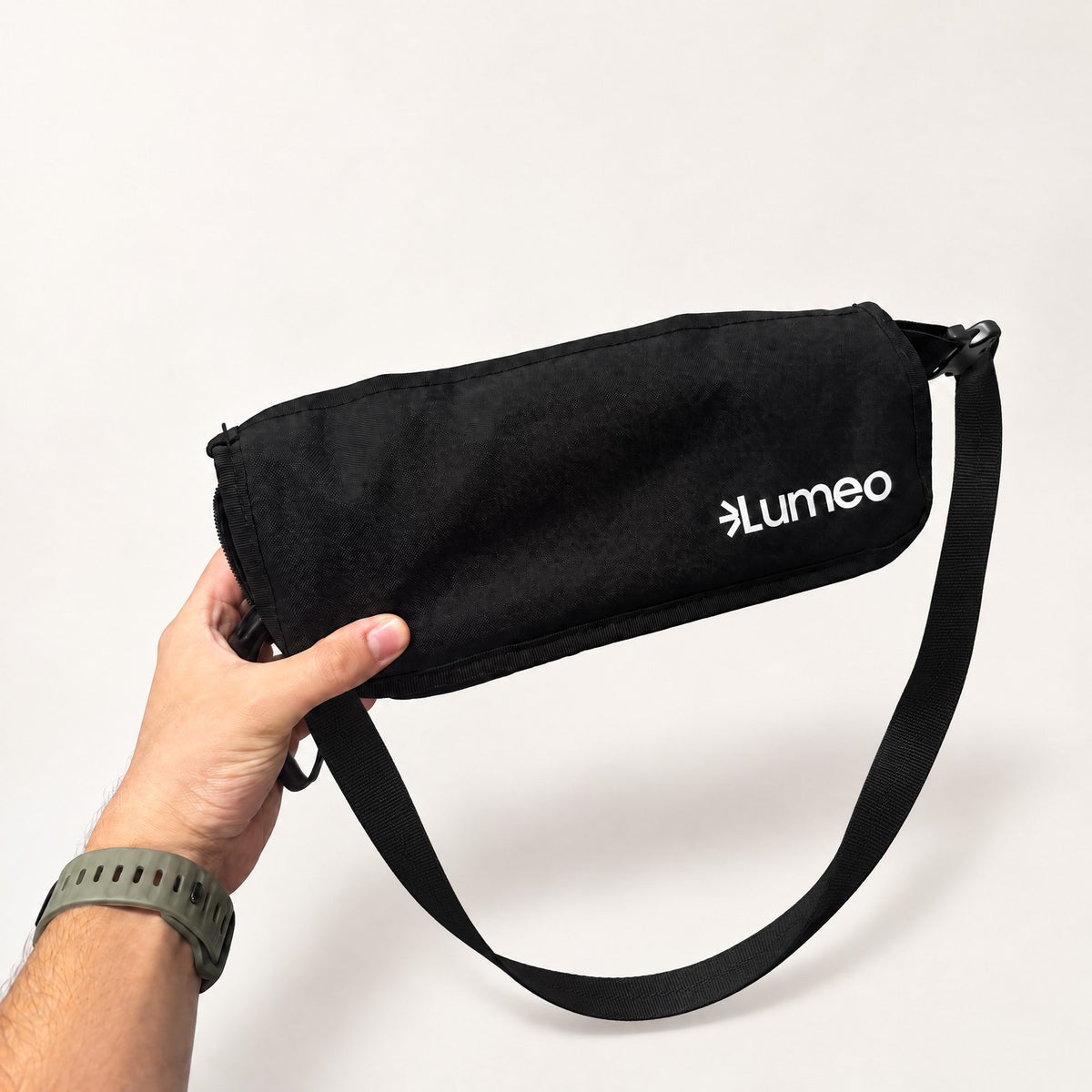 Lumeo Sling Stool folded into its shoulder bag, strap attached