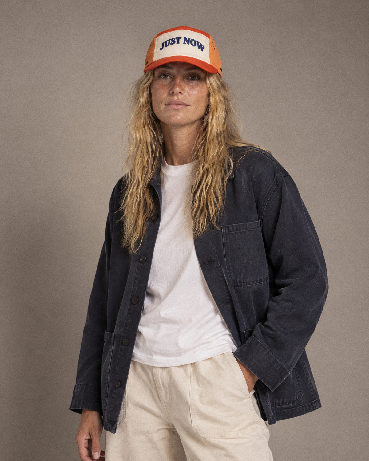 Studio portrait in the orange Just Now cap