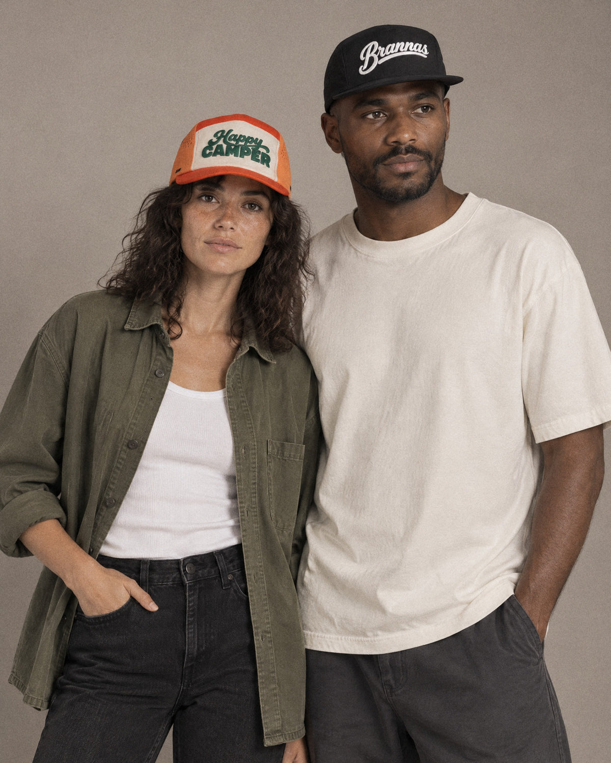 Studio portrait in orange Happy Camper and black Brannas caps